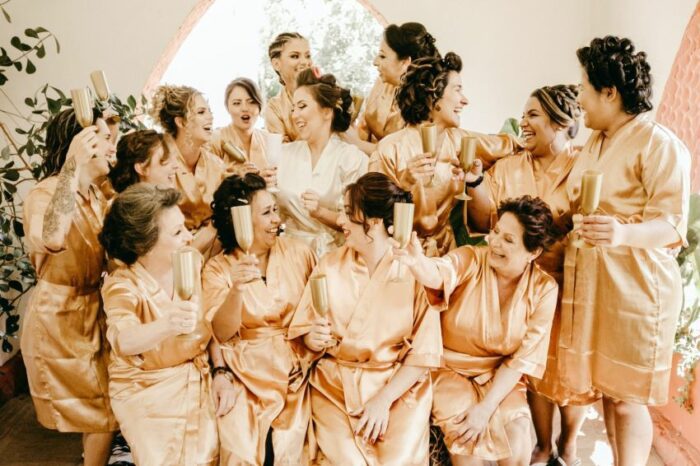 Group of bridesmaids and bride get ready for spa treatment in post about wedding guest entertainment